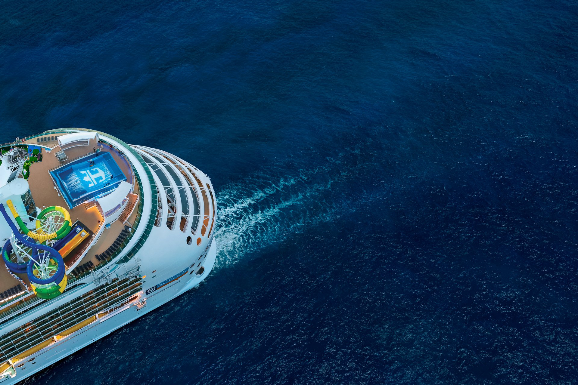 Royal Caribbean’s Explorer of the Seas pool deck and waterslides above the blue ocean